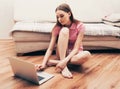 Young beautiful woman with laptop notebook on floor home surfing internet Royalty Free Stock Photo
