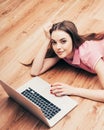 Young beautiful woman with laptop notebook on floor home surfing internet Royalty Free Stock Photo