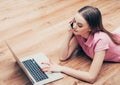 Young beautiful woman with laptop notebook on floor home surfing internet Royalty Free Stock Photo