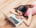 Young beautiful woman with laptop notebook on floor home surfing internet Royalty Free Stock Photo