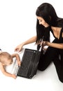 Young beautiful woman and little boy playing with laptop Royalty Free Stock Photo