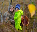 Young beautiful woman and little girl, picking ripe cranberries Royalty Free Stock Photo