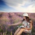 Romantic woman with book on lavender field Royalty Free Stock Photo