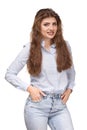 Young Beautiful woman with long curly hair smiling, holding hands in pockets Royalty Free Stock Photo