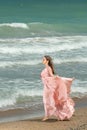 Young beautiful woman with long dress ,romantic mood on the beach with waves, Black sea side  Bulgaria Royalty Free Stock Photo