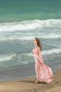 Young beautiful woman with long dress ,romantic mood on the beach with waves, Black sea side  Bulgaria Royalty Free Stock Photo