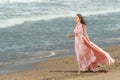 Young beautiful woman with long dress ,romantic mood on the beach with waves, Black sea side  Bulgaria Royalty Free Stock Photo