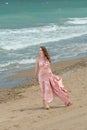 Young beautiful woman with long dress ,romantic mood on the beach with waves, Black sea side  Bulgaria Royalty Free Stock Photo