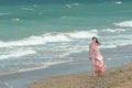 Young beautiful woman with long dress ,romantic mood on the beach with waves, Black sea side  Bulgaria Royalty Free Stock Photo