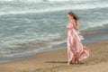 Young beautiful woman with long dress ,romantic mood on the beach with waves, Black sea side  Bulgaria Royalty Free Stock Photo