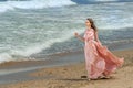 Young beautiful woman with long dress ,romantic mood on the beach with waves, Black sea side  Bulgaria Royalty Free Stock Photo