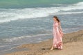 Young beautiful woman with long dress ,romantic mood on the beach with waves, Black sea side  Bulgaria Royalty Free Stock Photo