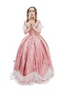 Young beautiful woman in long pink medieval dress pray  isolated Royalty Free Stock Photo