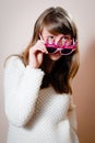 Young beautiful woman looking over funny pink glasses Royalty Free Stock Photo