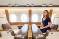 Young beautiful woman in Luxury interior in the business jet Royalty Free Stock Photo