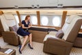 Young beautiful woman in Luxury interior in the business jet Royalty Free Stock Photo