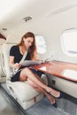 Young beautiful woman in Luxury interior in the business jet Royalty Free Stock Photo