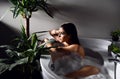 Young beautiful woman lying in bathtub and taking bath Royalty Free Stock Photo