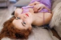 Young beautiful woman lying on bed, beautiful red hair, relaxation and relaxation concept Royalty Free Stock Photo
