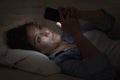 Young beautiful woman lying on home couch using mobile phone internet addiction concept Royalty Free Stock Photo