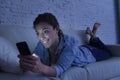 Young beautiful woman lying on home couch using mobile phone internet addiction concept Royalty Free Stock Photo