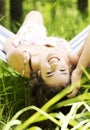Young beautiful woman lying and relaxing in a hammock. Royalty Free Stock Photo