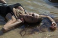 Young beautiful woman lying in water Royalty Free Stock Photo