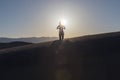 Young beautiful woman makes yoga fitness exercise on the sand mountain at sunset. Health lifestyle concept. Woman meditating Royalty Free Stock Photo