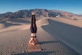 Young beautiful woman makes yoga fitness exercise on the sand mountain at sunset. Health lifestyle concept. Woman meditating Royalty Free Stock Photo