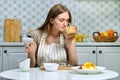 Young beautiful woman making fruit salad in kitchen Royalty Free Stock Photo