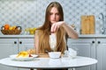 Young beautiful woman making fruit salad in kitchen Royalty Free Stock Photo