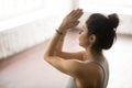 Young beautiful woman making namaste gesture, loft studio backgr Royalty Free Stock Photo