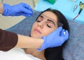 Young beautiful woman making permanent makeup in cosmetology salon. Royalty Free Stock Photo