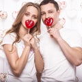 Young, beautiful woman and man in love on Valentine's Day with candy, Laughing Happy Lovers, showing different poses. Royalty Free Stock Photo