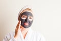 Young beautiful woman in a mask for the face of the therapeutic black mud Royalty Free Stock Photo