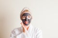 Young beautiful woman in a mask for the face of the therapeutic black mud Royalty Free Stock Photo