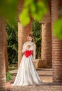 Young beautiful woman with medieval dress , romantic mood with white lace dress and fan