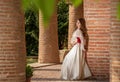 Young beautiful woman with medieval dress , romantic mood with white lace dress and fan