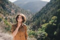 Young beautiful woman in a modern dress with mehendi posing among mountains Royalty Free Stock Photo