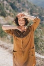 Young beautiful woman in a modern dress with mehendi posing among mountains Royalty Free Stock Photo