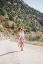 Young beautiful woman in a modern dress with mehendi posing among mountains Royalty Free Stock Photo