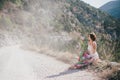 Young beautiful woman in a modern dress with mehendi posing among mountains Royalty Free Stock Photo