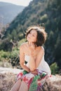 Young beautiful woman in a modern dress with mehendi posing among mountains Royalty Free Stock Photo