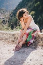 Young beautiful woman in a modern dress with mehendi posing among mountains Royalty Free Stock Photo