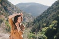 Young beautiful woman in a modern dress with mehendi posing among mountains Royalty Free Stock Photo