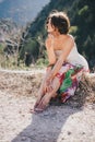 Young beautiful woman in a modern dress with mehendi posing among mountains Royalty Free Stock Photo