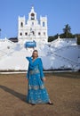 The young beautiful woman in national Indian clothes near the Catholic temple, Goa