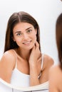 young beautiful woman near mirror on Royalty Free Stock Photo