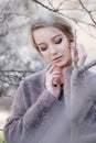 Young beautiful woman near trees in blossom in spring. Hair style bound Royalty Free Stock Photo