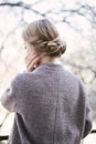 Young beautiful woman near trees in blossom in spring. Hair style bound Royalty Free Stock Photo